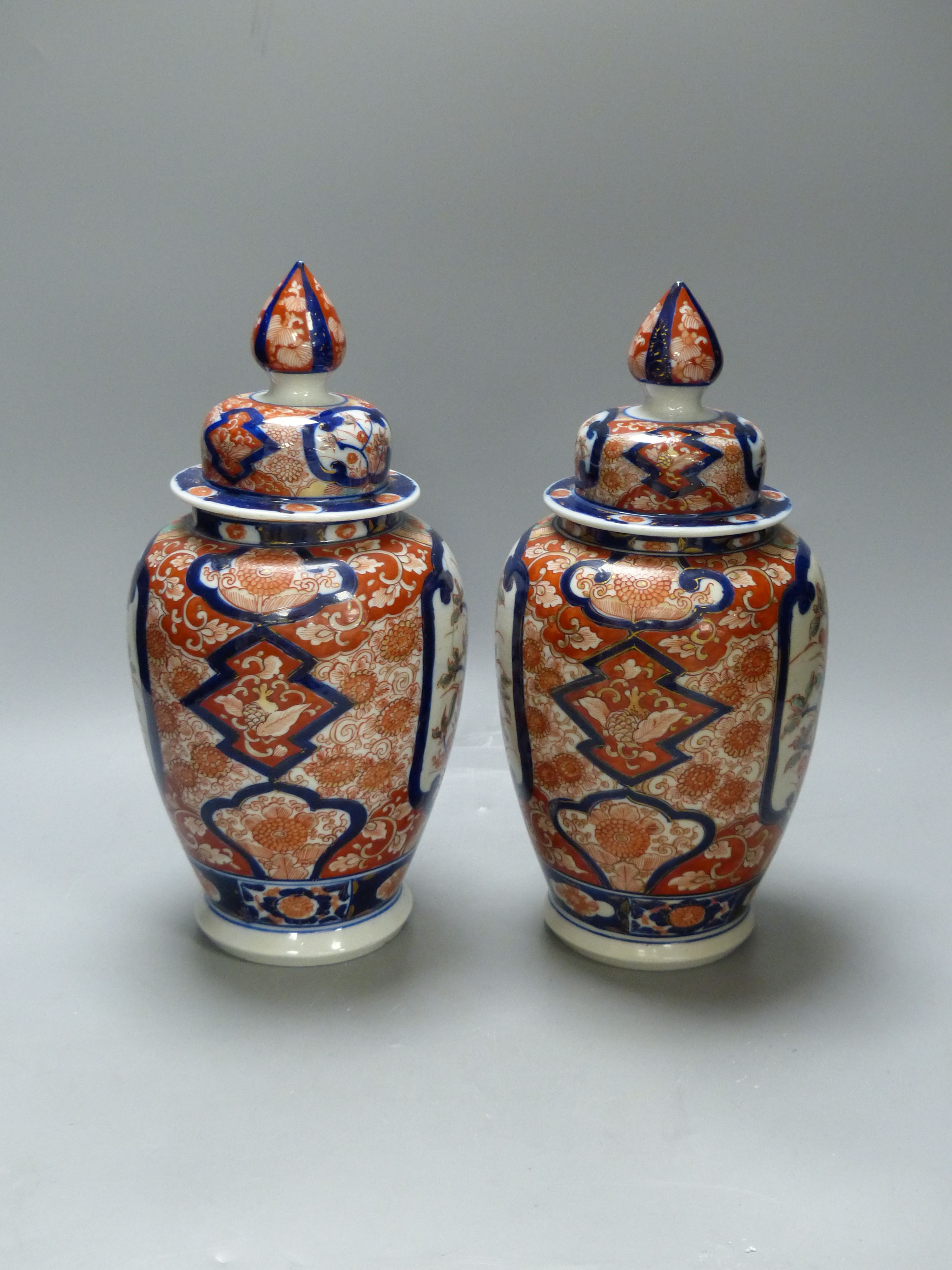 A pair of Imari vases and covers and a Limoges box, height 30cm